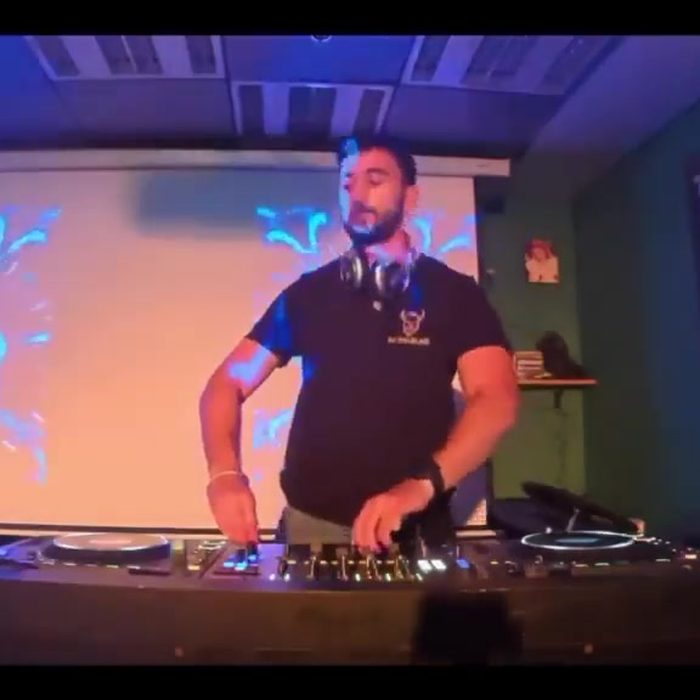 Main-room set with projections filling the wall behind the booth