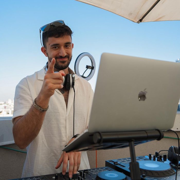 DALELAD on a Tel Aviv rooftop, pointing at the camera mid-set