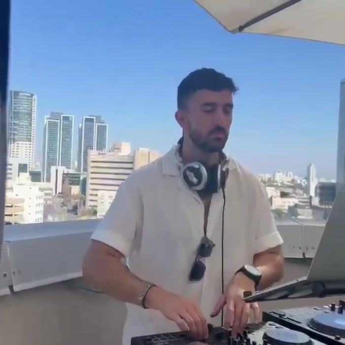 Daytime rooftop set with the Tel Aviv skyline behind the decks