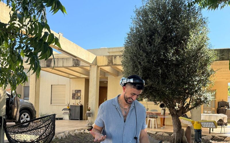 DALELAD playing a daytime garden set under a clear sky