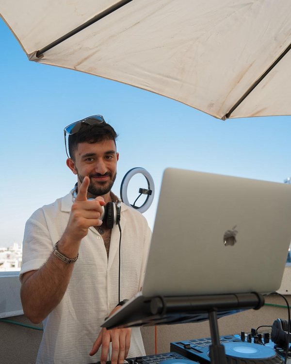 DALELAD looking straight at camera during a Tel Aviv rooftop set