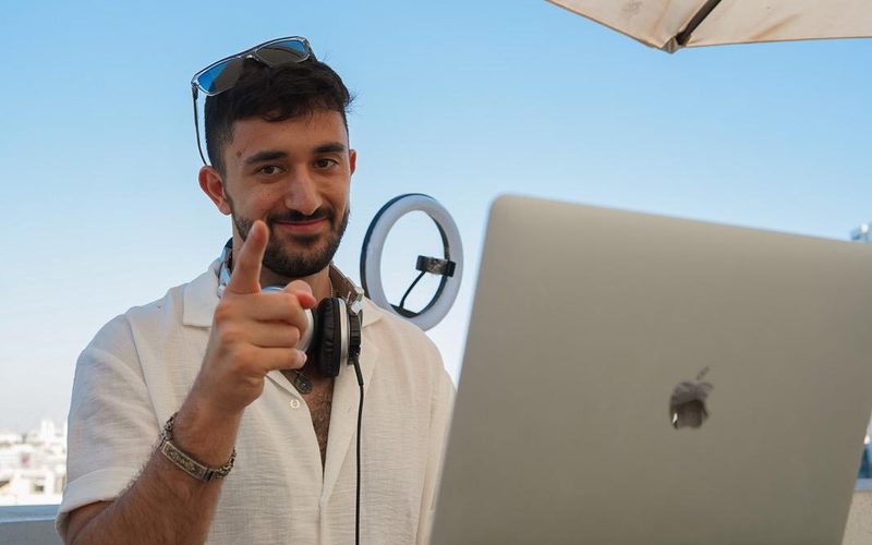 Daytime rooftop set with the Tel Aviv skyline behind the booth